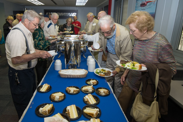 Alumni and their guests make their way through the buffet line. 
