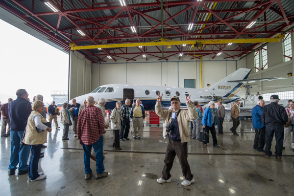 Attendees enjoy a tour of the hangar, including “93-year-old kid” Carl McDaniel, who took machine shop classes at WTI and playfully engages the camera on reunion day.