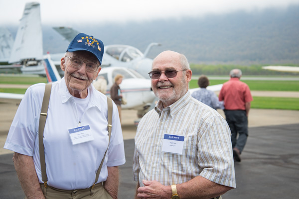 Enjoying the Aviation Center surroundings are John Hertel, (left) ’48, agricultural equipment and repair, and ‘49, electric and acetylene welding, and Ralph Mills, ’58, plumbing.