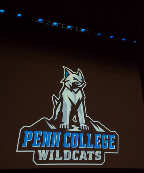 A proud 'cat makes its debut under Wildcat blue stage lights.