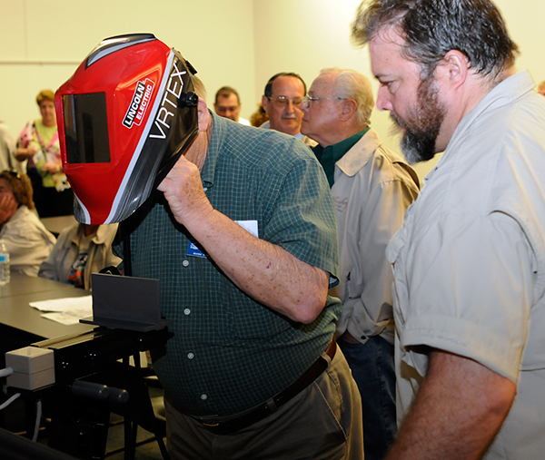 The Hershey Region's Jack Sekol gauges his steady hand on a welding simulator, alongside welding instructor Matthew W. Nolan.