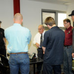 Haubert swaps stories with interested students and faculty.