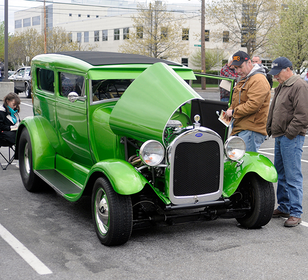 A 1928 Ford Model A offers a splash of spring green after the Saturday morning rain, casting many envious spectators with a similar hue.
