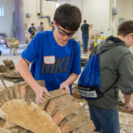 “Jordan B.” carefully adds a brick to an archway. Twenty of 20 arches built throughout the morning remained intact when the wooden form was extracted.