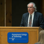Tom Gregory, a presence at all three of the day's ceremonies, delivers closing remarks at the Delta Mu Delta gathering.