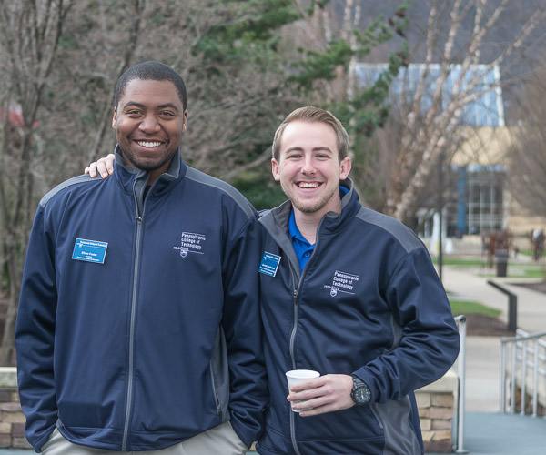 Pleasantly fulfilling their tour duty are Presidential Student Ambassadors Efrem K. Foster (left) and Garret D. Corneliussen.