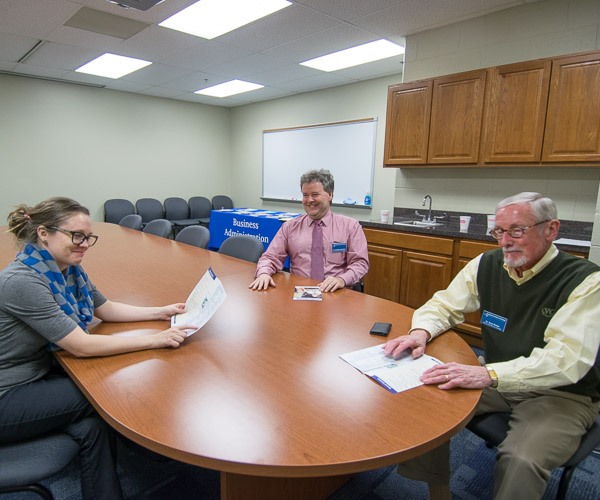 Faculty jovially triple-team inquiring minds on majors including the college's new business administration: sport and event management concentration. From left are Summer L. Bukeavich, Chip D. Baumgardner and Terry A. Girdon.