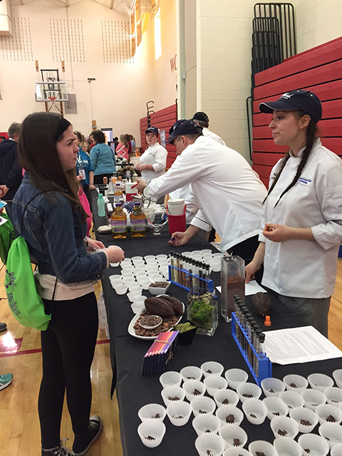Zaczkiewicz helps a visitor analyze the allure of chocolate.