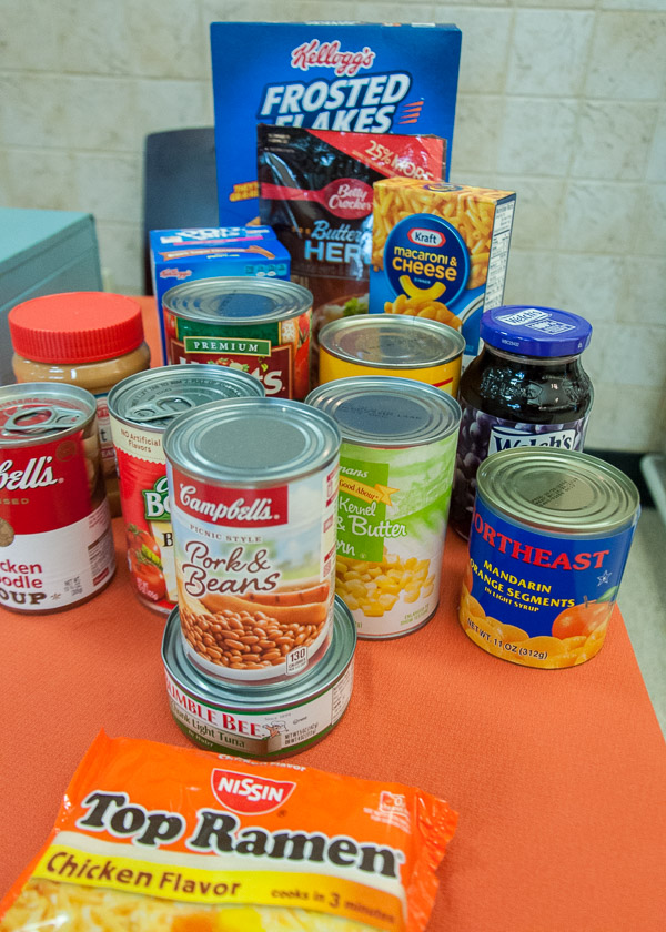 Displayed is a sample of the provisions a student would receive from The Cupboard, with the intention to help them eat for a week. They would also receive a loaf of bread.