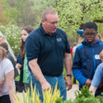 Horticulture instructor Carl J. Bower Jr. guides Warrior Run fourth-graders in a sensory exploration of the ESC’s plant life.