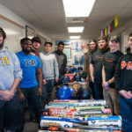 Preparing the donations for delivery takes a team effort. From left are Nicholas D. Reitz, Semeon R. DeBarros, Robert L. Sloss, Thomas M. Malason Jr, Andrew A. Smith, Vander Vere, Brendon J. Dibble, Andrew J. Brady, Colin D. McOdrum and Austen J. Caron. 
