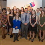 The 17 celebrated graphic designers pose for a group photo in the gallery. 