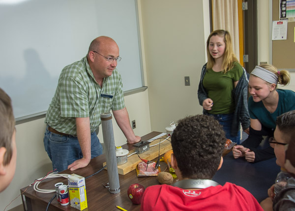 In the Electrical Technologies Center, Eric L. Anstadt, lecturer in electrical technology occupations, allows visitors to test a variety of materials to determine their conductivity.