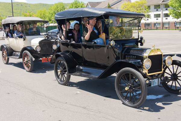 Roy H. Klinger and Shaun D. Hack, instructors of collision repair, take a group for a spin in a pair of Ford Model T’s.
