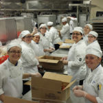 On their first day at Churchill Downs, students unpack chocolate bars as they begin preparing 4,000 bourbon-caramel s’mores.