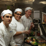 Culinary arts and systems students R. Colby Janowitz, of Westminster, Md; Amaris T. Smith, of Williamsport; and Cy C. Heller, of Milton, work an à la carte lunch in the Turf Room on Oaks Day.