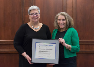 June Kilgus Zimmerman, a liberal arts graduate of Penn College predecessor institution Williamsport Area Community College, is presented with a Distinguished Alumni Award by the president.