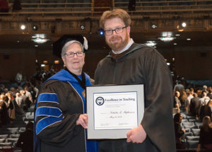 Nicholas L. Stephenson, instructor of graphic design at Penn College, is presented with an Excellence in Teaching Award.