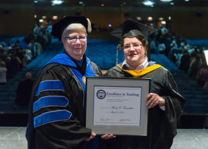 Mary G. Trometter, assistant professor of hospitality management/culinary arts, receives an Excellence in Teaching Award from the college president.
