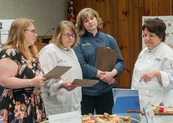 Chef Mary G. Trometter (right), assistant professor of hospitality management/culinary arts, confers with judges (from left) Kate Hunter, ’00; Sue L. Mayer, ’85 and ’96; and Samantha L. Liedtka-Gundlach, ’10.