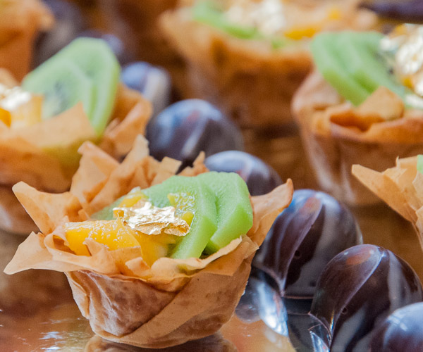 Santaella’s phyllo fruit tarts line up next to her coconut almond truffles.