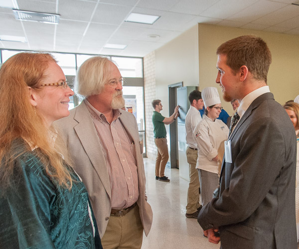 Dorothy J. Gerring, associate professor of architectural technology and Penn College Education Association president, and Bill Geyer, retired assistant professor of building construction technology, chat with George W. Settle III, a welding and fabrication engineering technology student and recipient of the PCEA scholarship.