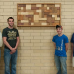 From left: Peter Kruppenbacher, assistant professor of building construction technology, and students Zachary Ridall, Aaron White and Tyler Arthur, who helped to design the piece.