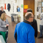 In the Machining Technologies Center, a group talks with a member of the Baja team, which is putting the final touches on the off-road vehicle it has manufactured from the ground up. The team will enter the first of two collegiate competitions in 18 days, he said.