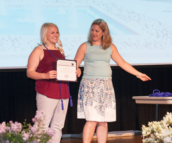 Alayna R. Bertothy, of Phillipsburg, accepts her membership certificate from Jessica L. Bower, laboratory coordinator for nursing education.