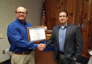 Timothy S. Turnbach (left),  an instructor of welding at Penn College, receives the Howard E. Adkins Memorial Instructor Section Award from Michael S. Sebergandio, American Welding Society District 3 director, during a recent ceremony at the college.