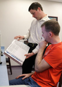 Penn College’s Michael D. Shipman, left, instructor of business administration/accounting, reviews tax policy with student Joshua D. Lyman, of Williamsport. Lyman is one of 16 Penn College students certified by the IRS to offer free tax help to the community through the Volunteer Income Tax Assistance program.