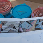 Stabley's original sketch lies atop plastic containers of mosaic tile.