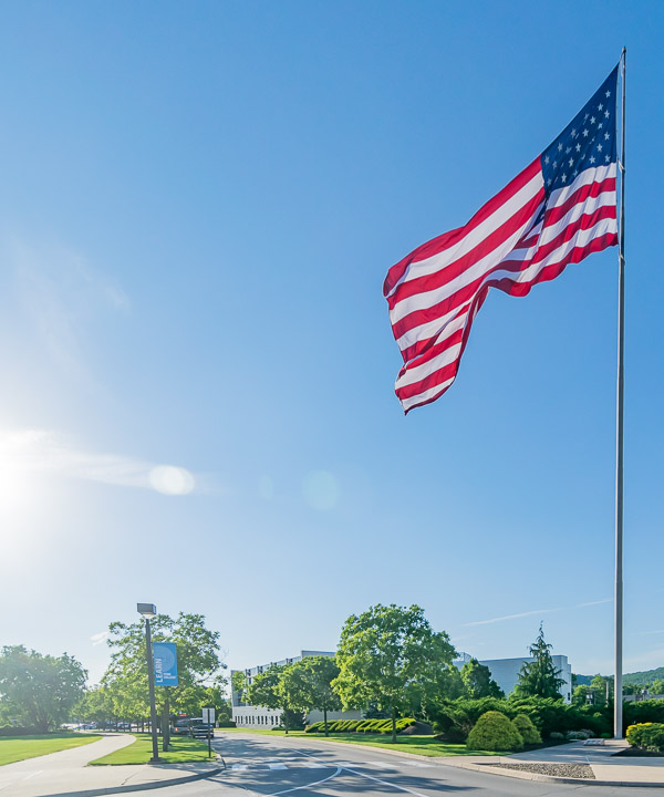Measuring 1,800 square feet, the largest American flag permitted to fly from a pole, the Stars and Stripes swells with national pride in a pre-summer evening's breeze.