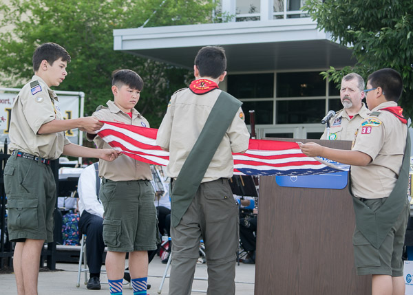 Scouts exhibit the proper way to fold a flag.