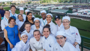 A portion of the Penn College contingent – along with a representative of Guittard Chocolate Co., the college’s chocolate supplier – gather for a photo above the historic track.