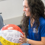 Putting incoming students at ease with a soothing smile and a now-traditional activity, Alexandra D. Petrizzi prepares to circulate a beach ball covered with conversational prompts. A graphic design major from Langhorne, the Connections Link facilitated the sharing of students' passions and pop-culture preferences.