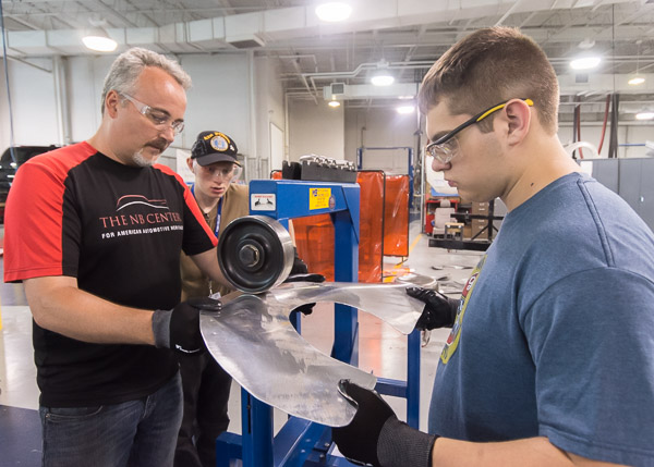 Collision repair instructor Roy H. Klinger (left) conducts a metalforming workshop during Automotive Restoration Camp ...