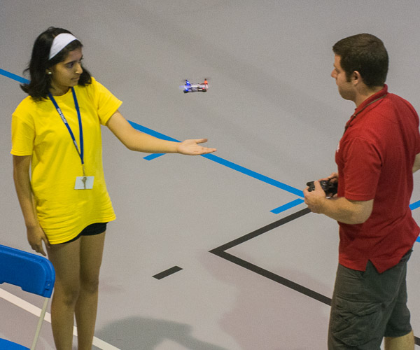 Doctorick shows the capabilities of one of the high-schooler-designed copters, landing it on her hand.