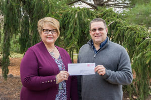 Debra M. Miller, college relations advisor at Penn College, accepts a Herman O. West Foundation grant from Dave Lanzer, director of operations at West Pharmaceutical Services Inc. The grant will be used to establish an endowed scholarship at the college. 