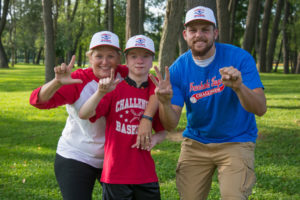 From left, Sarah S. Moore, Travis Mikulka and Korey T. Keyser sign "L," "L," and "W.S." for Little League World Series during their "awesome" weekend of teamwork.