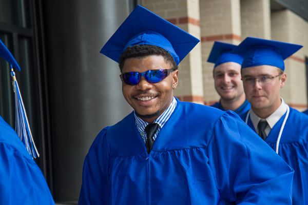 Titus B. Green's Wildcat Blue sunglasses and a self-assured smile are the perfect fashion accessories for summer commencement. Green, of Glenside, graduated in collision repair technology. 