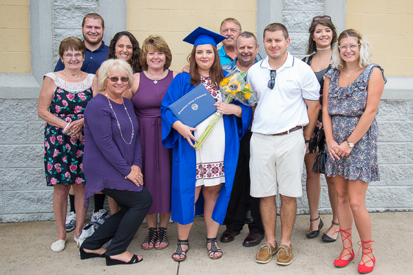 With sunflowers on her shoulders (and a diploma, too!), Megan L. Bartlett, a health arts: practical nursing emphasis graduate from Montgomery, savors the day with family and friends.