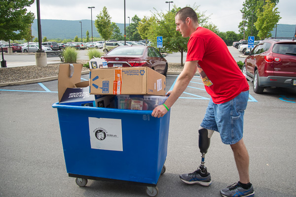 Inspiration incarnate: Ryan J. Lariviere, a Sigma Pi Fraternity brother, volunteers his time for move-in. Following a motorcycle accident and an amputation, he received such good care in the hospital that he enrolled in nursing, encouraging anyone in a similar situation to “not stop living your life.”
