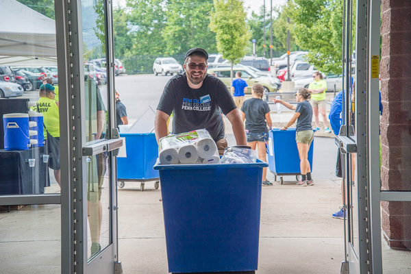 Blue bins and wide grins! RA Joshua M. Worthing lends a hand. 