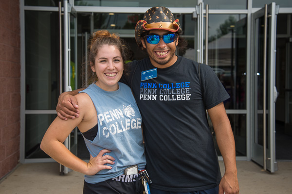 Softball player Tiana F. McCormick, volunteering with Athletics, enjoys a laugh with RA Christopher J. Morrin. 