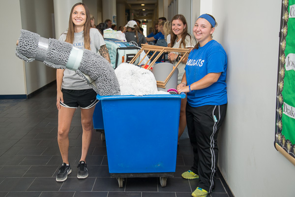 Waiting for an elevator are freshman Amber J. Janelli (center), a health information technology student from Denver, and two Wildcat Athletics helpers: Amelia “Millie” Landry (left), a soccer player from Lodi, Calif., and Madeline P. Wenk, a basketball and soccer player from Biglerville. 