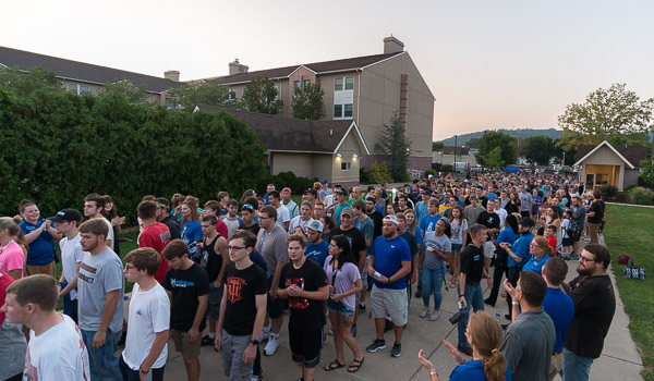 To the applause of Penn College employees, accented with glow-stick bracelets, first-year students make their symbolic entry to campus for convocation.