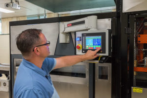 Christopher J. Gagliano, program manager for Penn College’s Thermoforming Center of Excellence, operates the new equipment.