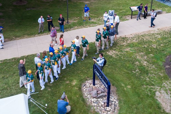 Members of President's Council greet players as they enter the picnic grounds on the west side of the Bush Campus Center.