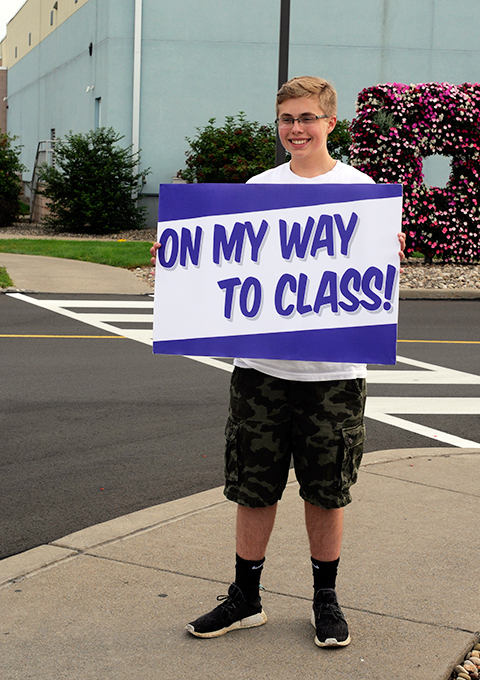 With contagious enthusiasm, Brandon T. Reeves, of Harleysville, heads for his first class Monday morning. The early riser is enrolled in the college's graphic design major.